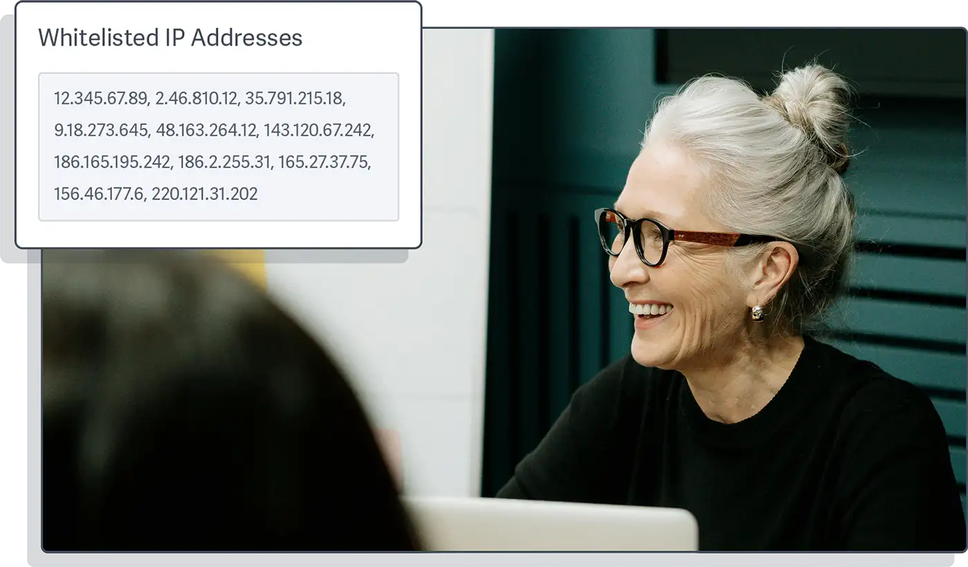 Safeguard sensitive content from unauthorized access and sharing by controlling access through viewer login protection, whitelisted domains and IP addresses, and geo-restrictions. Image of a professional woman conducting a meeting with a stylized example of the UI for whitelisting IP addresses from the SproutVideo platform overlaid