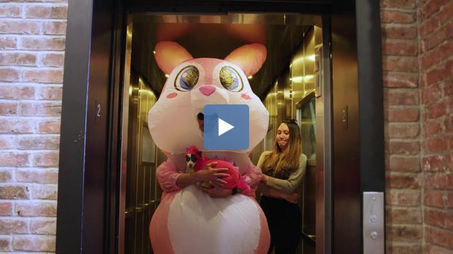woman disturbed by giant costume in elevator